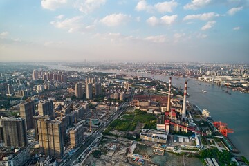 Aerial view of Yangshupu Power Plant Site Park showcasing urban landscape and river in modern city