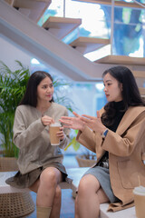 Mature entrepreneur wearing headphones engages in a video call, pointing at his laptop screen while working from the comfort of his home office during the evening