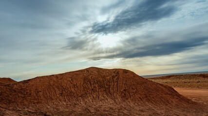 Experience the vibrant autumn landscape of Dahong Mountain in Inner Mongolia with dramatic skies and rich earth tones