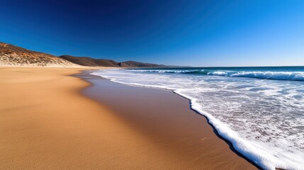 Serene Beach Landscape with Gentle Waves and Clear Blue Sky