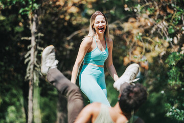 Happy friends in a park enjoying exercise, laughing and having a good time amidst nature.