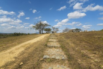 Fototapeta premium Exploring the ancient Xieng Khouang stone tank plains in Laos under a clear blue sky and minimal vegetation