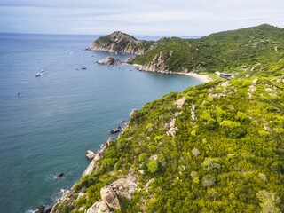 Naklejka premium Vinh Creek Beach Resort in Vietnam showcasing stunning aerial views of coastline and lush greenery during a clear summer day