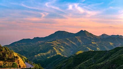 Beautiful summer sunset view at Yanmen Pass in Shanxi with rolling green hills and colorful sky