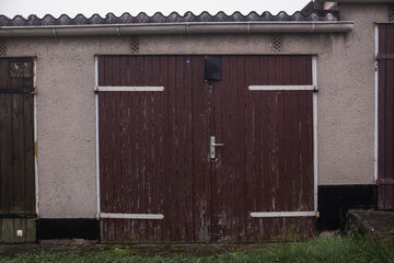 Garage gates in a garage cooperative. Brown wooden gates of the entrance to a private garage