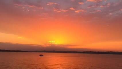 Fiery Sunset over Calm Lake with Sailboat