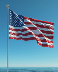 Obraz premium Waving American flag on tall silver flagpole against blue sky