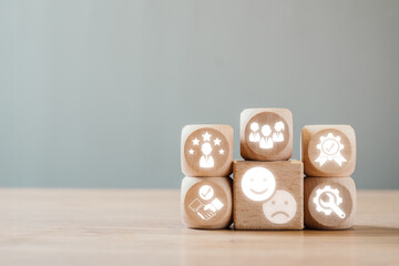 Wooden blocks with feedback icons symbolizing communication, improvement, and teamwork on a wooden...