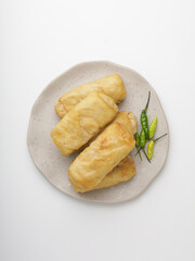 Rissole with vegetable ragout filling on white plate