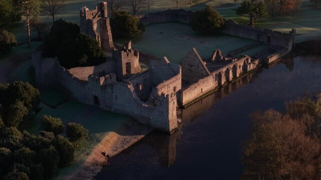 Desmond Castle Ruins In Adare By The Maigue River At Sunrise In Ireland. - zoom out shot