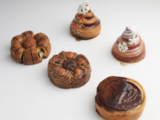 Various sweet pastries on white background