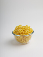 Conchiglie pasta in a bowl on white background