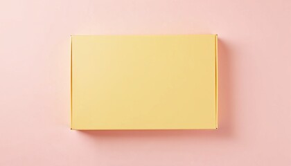 Yellow gift box on pastel pink background