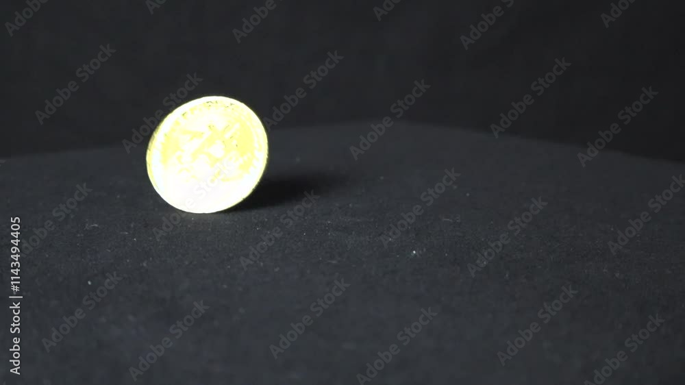 Poster bitcoin golden yellow cryptocurrency coin spinning in slow motion on a dark background and table cre
