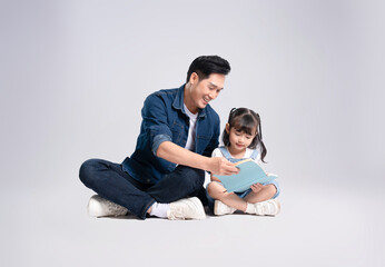 Full body image of Asian father and daughter posing on white background