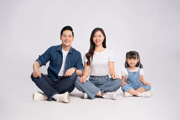 Full body image of Asian mother and daughter posing on white background