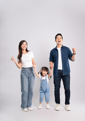 Full body image of Asian mother and daughter posing on white background	