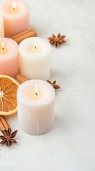 Festive Candle Arrangement with Dried Citrus and Spices on Light Background