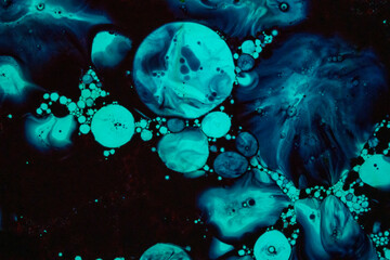 Blue liquid bubbles forming celestial-like patterns
