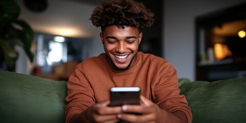 Stylish young man engaging with mobile apps while relaxing on the sofa.