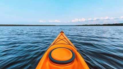 Bright Orange Kayak on Calm Waters Under Clear Blue Sky