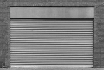 Closed steel shutter door of warehouse, storage or storefront for metal door background and textured