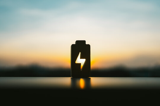 Technology battery high power electric energy with a connected charging cable. Battery to electric cars and mobile devices with clean electric, Green renewable energy battery storage future.