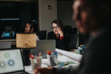 A diverse group of colleagues engaged in deep concentration, working on a project together in an...
