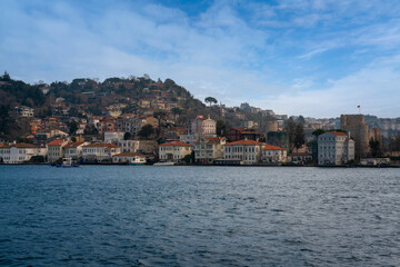Fototapeta premium Anadolu Hisari neighborhood in Beykoz district against the background of the Anatolian Fortress from the waters of the Bosphorus Strait on a sunny day, Istanbul, Turkey