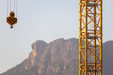 December 17, 2024,Hong Kong.Construction cranes in Hong Kong with the famous Lion Rock in the background.