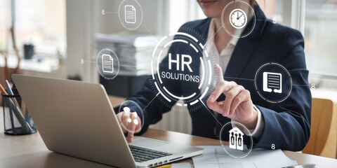 Businesswoman using laptop for HR solutions management