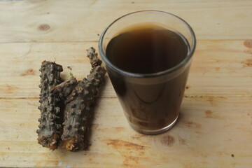 a glass of brotowali juice.