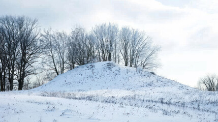 Simple snow-covered hill against a pale winter sky, pure and peaceful