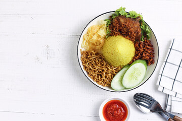 Cone shaped yellow rice or nasi tumpeng mini. Indonesian traditional cuisine for celebration. Perfect for recipe, article, catalogue, photo illustration, or any commercial purposes.