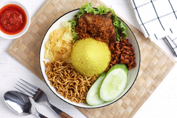 Cone shaped yellow rice or nasi tumpeng mini. Indonesian traditional cuisine for celebration. Perfect for recipe, article, catalogue, photo illustration, or any commercial purposes.