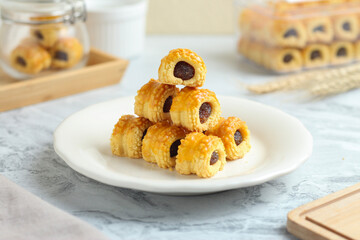 Nastar gulung or pineapple tart roll. Islamic holiday traditional snack or cookies. perfect for recipe, article, catalogue, or any commercial purposes.