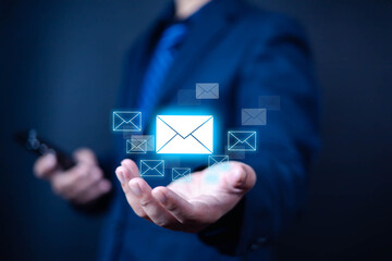 Businessman sending email message by smart phone to customer, Email marketing concept, Receiving smart phone message alert, digital technology email showing on a hand. Inbox, note, message
