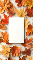 Obraz premium Blank card mockup surrounded by autumn leaves on white background for fall greeting card design.