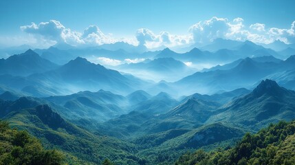 Naklejka premium Panoramic view of majestic blue mountains shrouded in mist under a vibrant sky.