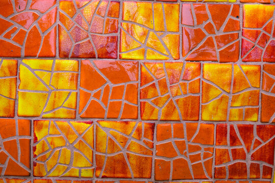 2023-12-31 A MULTI COLORED MOSIAC DESIGN WITH SHINY ORANGE AND YELLOW SQUARES