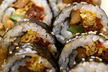 Gimbap or kimbap, Korean food made from cooked rice with vegetables, meat, egg and wrapped with...
