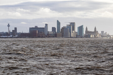 Heavy swell on River Mersey with city of Liverpool skyline in background