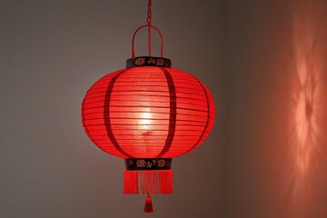 a close up of a red lantern hanging from a ceiling