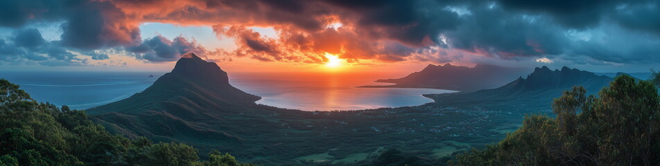 Fototapeta premium A panoramic photo of a beautiful sunset beach landscape in Mauritius where the blue sea, mountains, and coastline are in harmony.