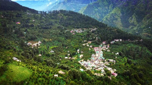 Beautiful drone shot of a village near kasol in Parvati valley with old rustic houses at the foothills of Himalayas in Himachal Pradesh, India