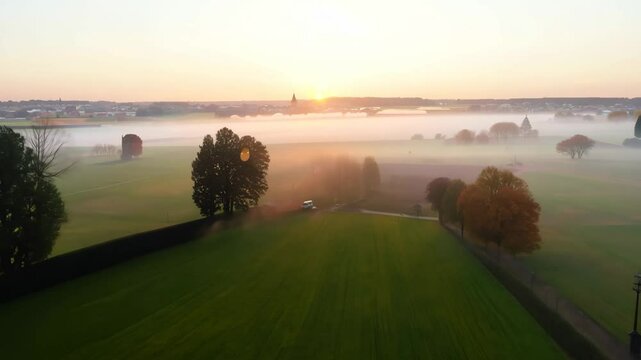 Aerial View of a Misty Sunrise Landscape Over a Fog-Covered Meadow in Bruges, Belgium