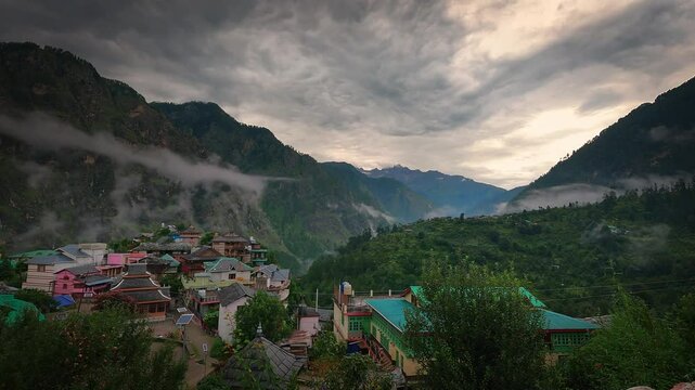 Beautiful timelapse shot of a village near kasol in Parvati valley with old rustic houses at the foothills of Himalayas in Himachal Pradesh, India