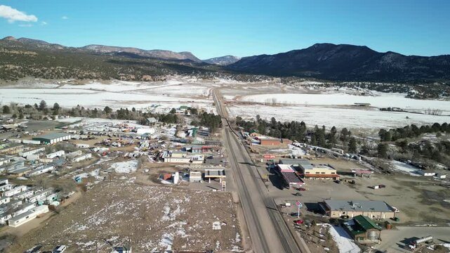 Aerial of Highway 285 in Buena Vista Colorado in winter with snowy fields