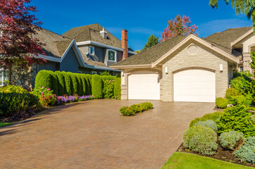 Garage door in luxury house with trees and nice landscape in Summer in Vancouver, Canada, North...