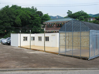 Buildings constructed by combining modular shipping containers, repurposed into cultural spaces,...